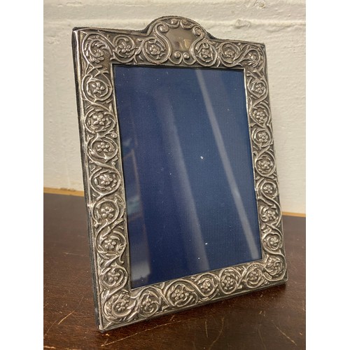 28 - A silver faced easel back photograph frame -