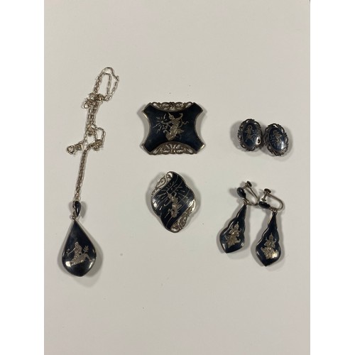 29 - A quantity of Siamese niello ware jewellery, including pendant on chain -