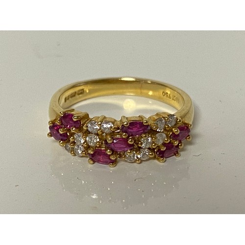 46 - An 18ct gold dress ring, set with three rows of marquise shaped rubies and circular diamonds -