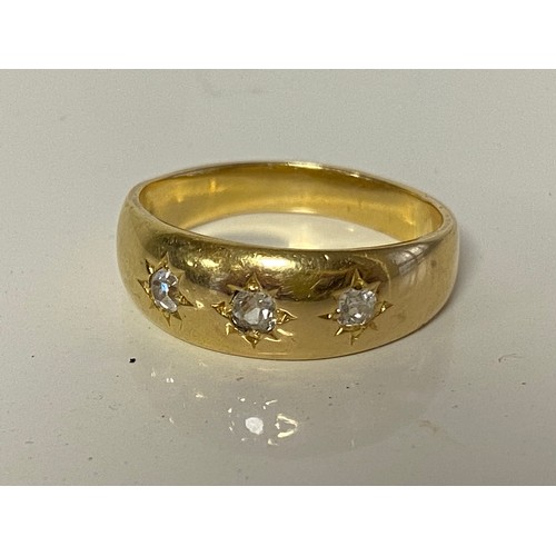 48 - A diamond three stone ring, the three old cut diamonds gypsy set to precious yellow metal mount -