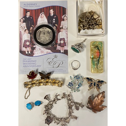 67 - A silver charm bracelet, together with a fob pendant, silver ring, silver coin, etc -