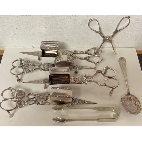 74 - A group of four pairs of silver plated candle snuffers/wick trimmers, together with tongs, etc -