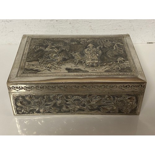 90 - A Chinese white metal box, the cover repousse decorated with figures and landscape -