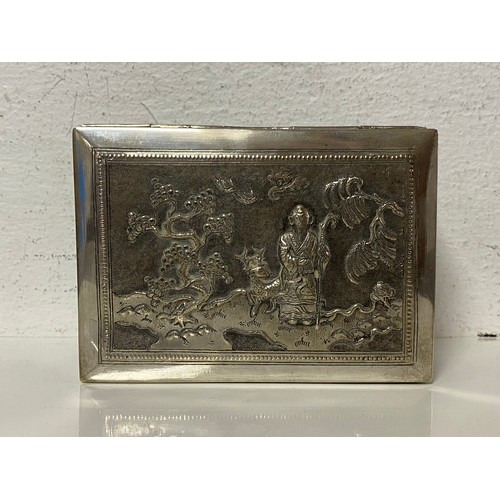 90 - A Chinese white metal box, the cover repousse decorated with figures and landscape -