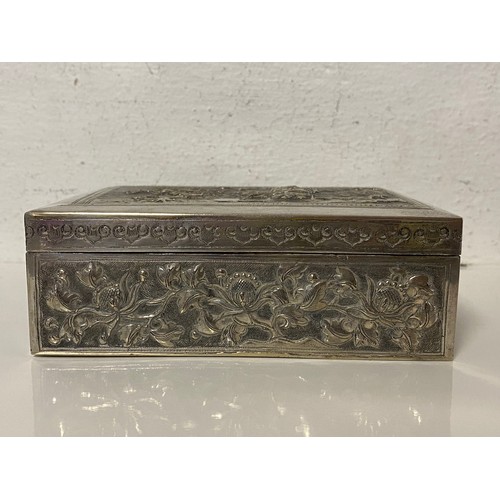 90 - A Chinese white metal box, the cover repousse decorated with figures and landscape -