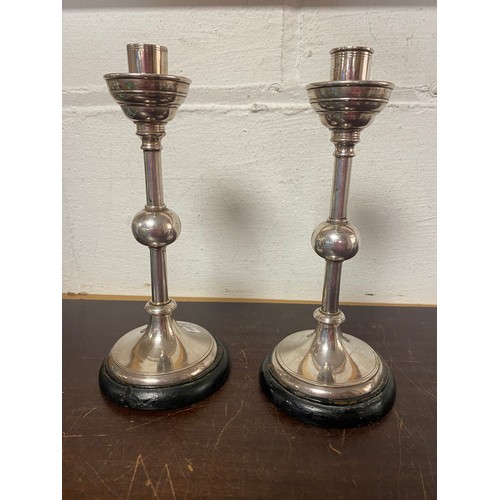 95 - A pair of Arts & Crafts style candlesticks, in the style of Christopher Dresser -