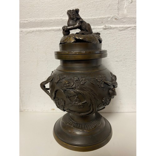 98 - A Japanese bronze censer, the cover with temple lion finial, the body cast with birds on branches -