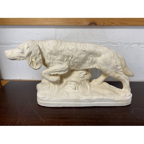 106 - A 20th century sculpture of a hunting dog, signed -