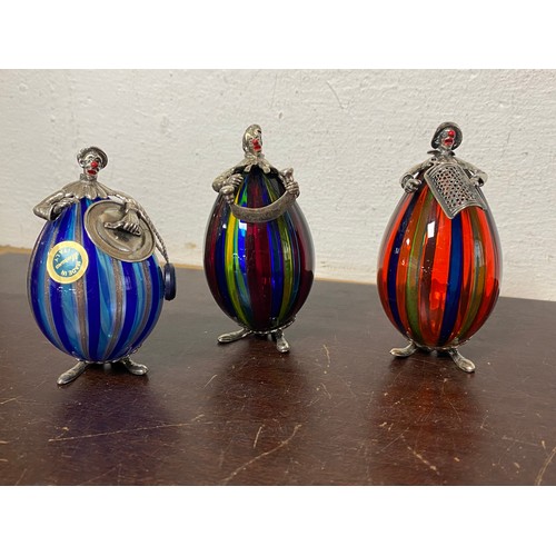 7 - A group of three silver mounted Murano glass clowns, each depicting a chef, together with a bottle s... 