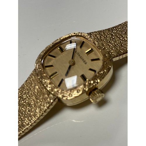 27 - A lady's 9ct gold Longines wristwatch, the signed dial with baton markers to textured 9ct gold brace... 