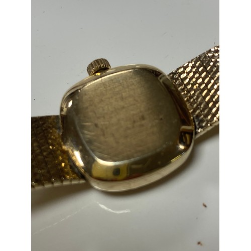27 - A lady's 9ct gold Longines wristwatch, the signed dial with baton markers to textured 9ct gold brace... 