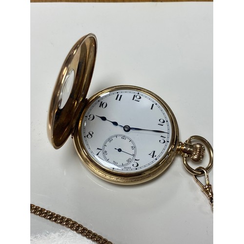 103 - A 9ct gold cased half hunter pocket watch to a 9ct watch chain suspending a 'T' bar and a Queen Vict... 
