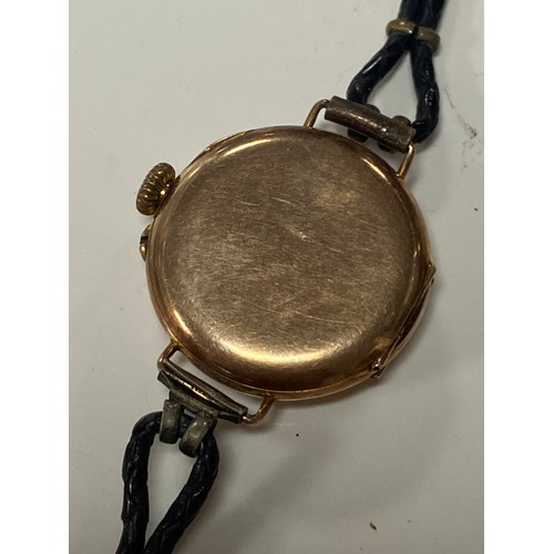 34 - A lady's 9ct gold cased wristwatch, the dial with arabic markers, to leather strap -