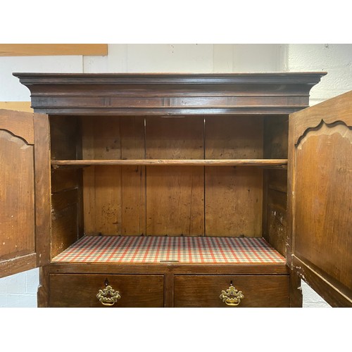 333 - An 18th century oak cupboard on chest, the top with two panelled doors over two drawers, the base fi... 