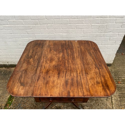 334 - A 19th century mahogany drop leaf dining table with two end drawers, centre pillar and four outswept... 