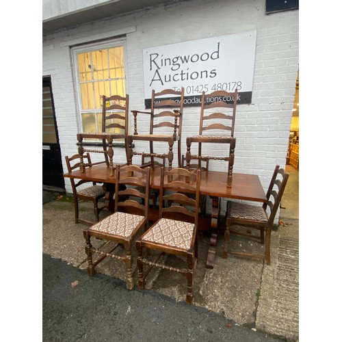 340 - An oak refectory style table, together with nine ladderback chairs -