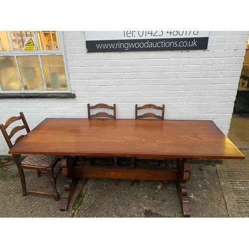 340 - An oak refectory style table, together with nine ladderback chairs -