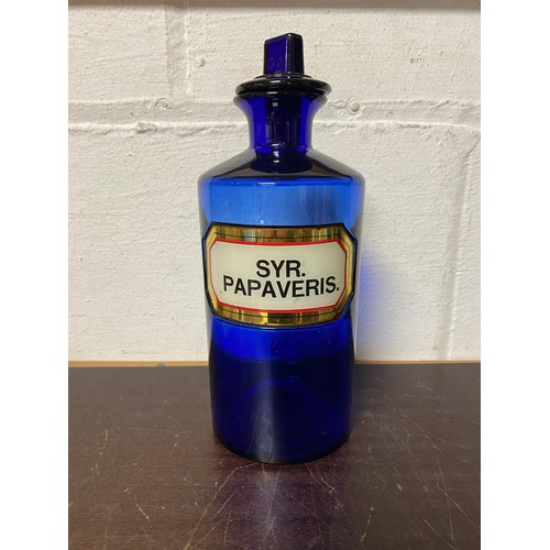 115 - A blue glass pharmacy bottle and cover, enamelled Syr. Papaveris -