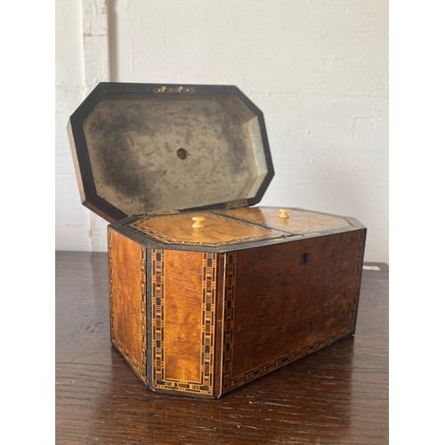 91 - A 19th century inlaid tea caddy, with canted corners, applied with crested plaque -