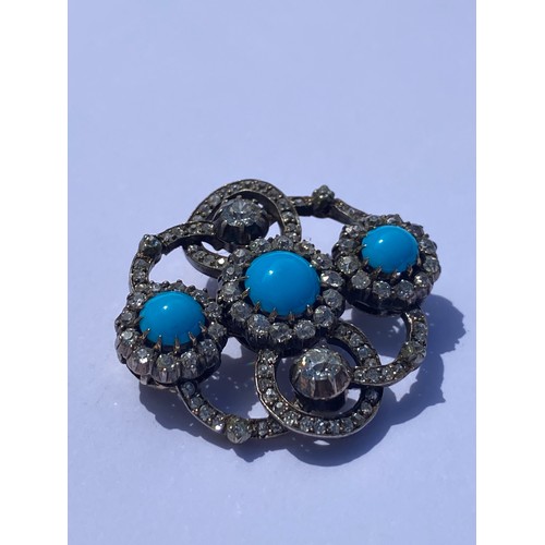 10 - A diamond and turquoise openwork brooch, set with three turquoise cabochons and diamond clusters wit... 