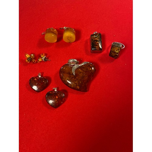 16 - A large silver mounted amber pendant, of heart shape and various pendants, rings and earrings -