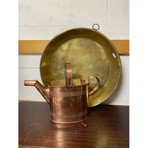 445 - A copper watering can, together with a brass pan -