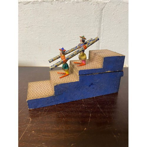 98 - A 19th Century acrobatic tumbling toy, featuring two carved and painted Chinese figures on a stepped... 