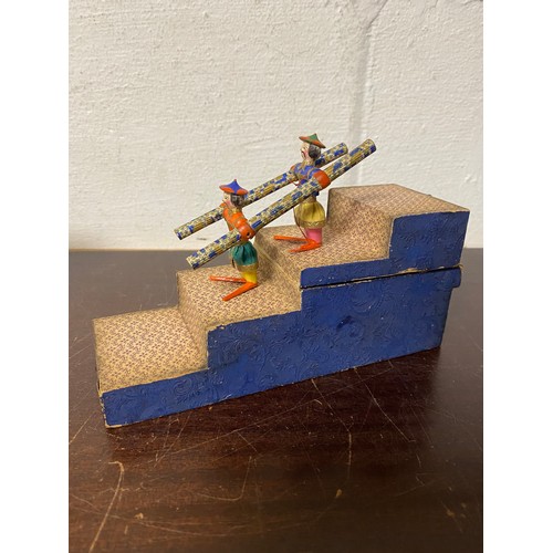 98 - A 19th Century acrobatic tumbling toy, featuring two carved and painted Chinese figures on a stepped... 