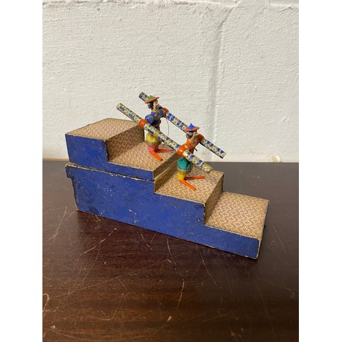 98 - A 19th Century acrobatic tumbling toy, featuring two carved and painted Chinese figures on a stepped... 