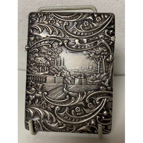 38 - An Edwardian silver card case, Birmingham 1901, decorated with figures in a terraced garden -