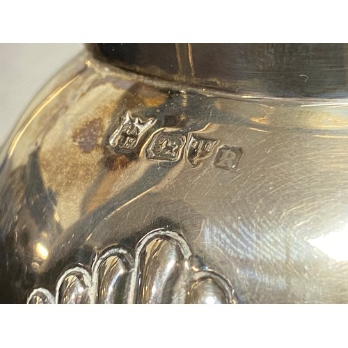 48 - An Edwardian silver teapot, marks rubbed and a similar milk jug, Chester 1900 -