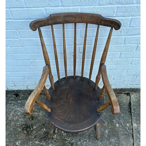 382 - An elm seated stick back open armchair, on ring turned legs -