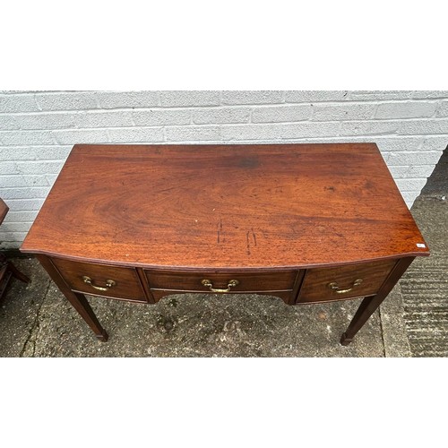 396 - A Georgian style bow fronted mahogany sideboard, fitted with three drawers, on tapering legs and spa... 