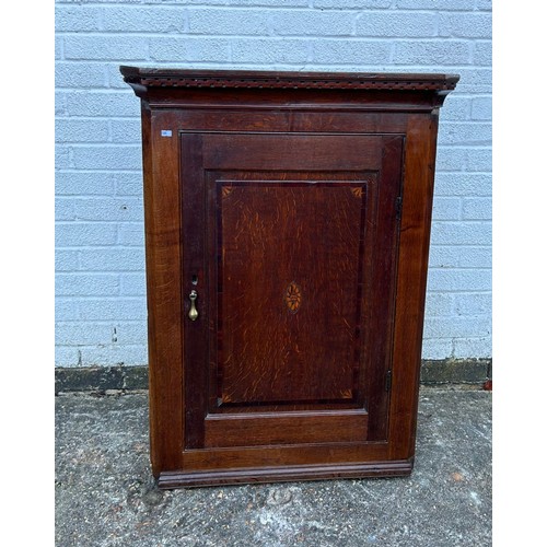 398 - A 19th Century oak corner cupboard, with inlaid door -