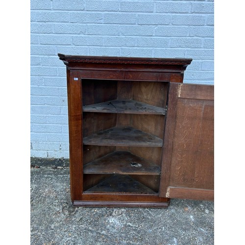 398 - A 19th Century oak corner cupboard, with inlaid door -