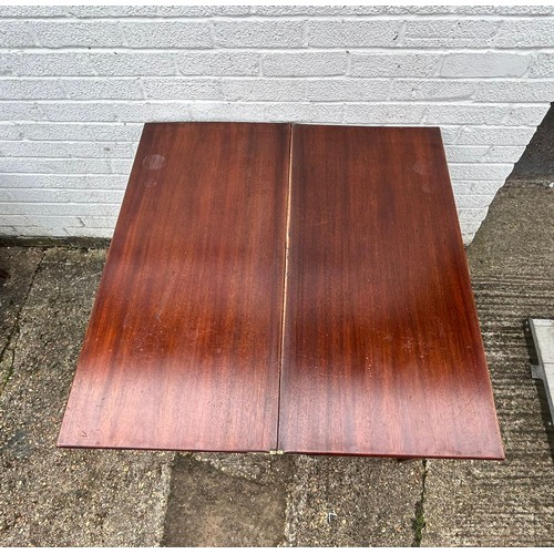 403 - A 19th Century mahogany fold over tea table, with single drawer, on square legs -