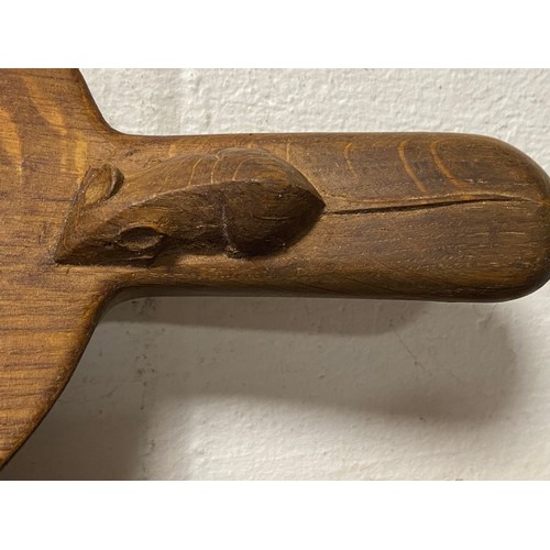 107 - Mouseman: A Robert Thompson oak cheeseboard, the handle carved with typical mouse -