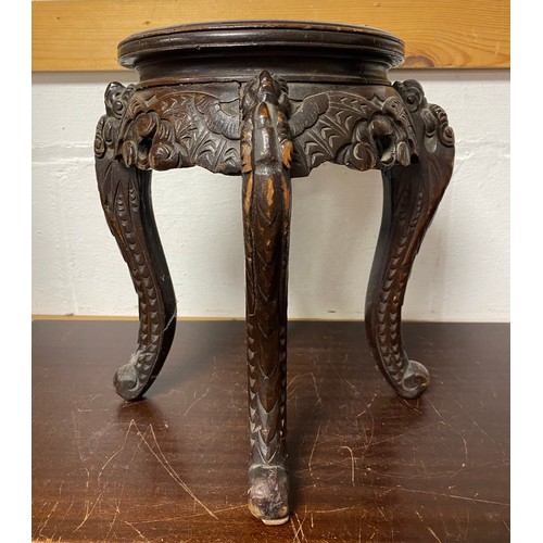 108 - A Chinese carved hardwood stand, circular top on four legs, carved with bats  -