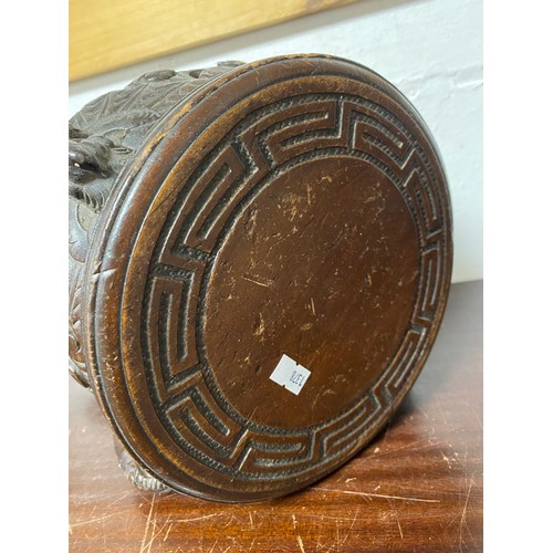 108 - A Chinese carved hardwood stand, circular top on four legs, carved with bats  -