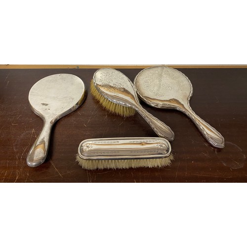 58 - A group of four silver dressing table items -