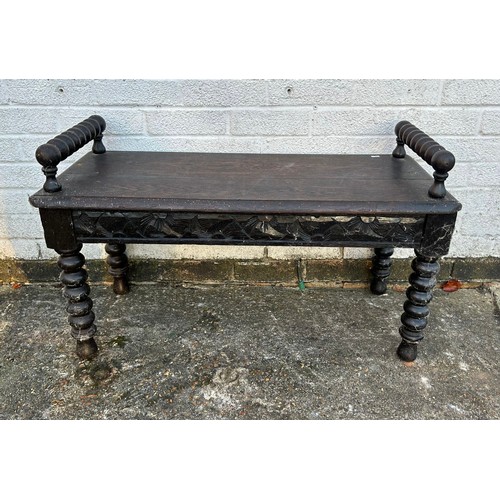 413 - A carved oak window seat/bench, with bobbin turned supports and legs -