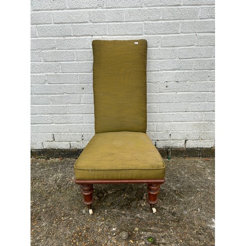 417 - A green upholstered chair with an inlaid footstool -