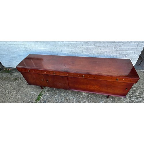 423 - A mid-century modern sideboard, fitted with four drawers over cupboard doors and a sliding door -