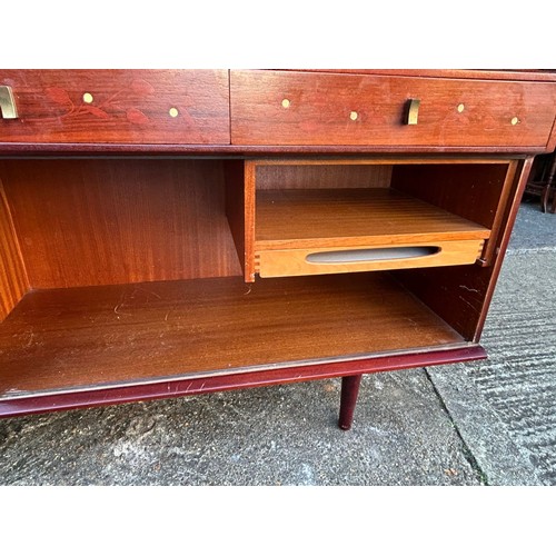 423 - A mid-century modern sideboard, fitted with four drawers over cupboard doors and a sliding door -