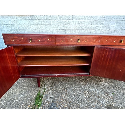 423 - A mid-century modern sideboard, fitted with four drawers over cupboard doors and a sliding door -