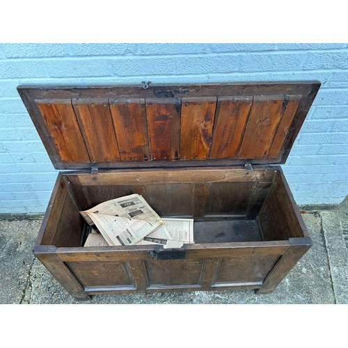 430 - An 18th Century oak coffer, with panelled top, front and sides -