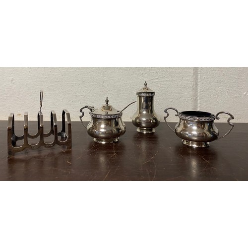 62 - An Edwardian silver three piece cruet, by Walker and Hall Sheffield 1906, together with a silver toa... 