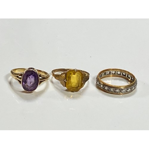 66 - A 9ct gold ring set with an oval amethyst, together with a 9ct citrine ring, and an eternity band (3... 