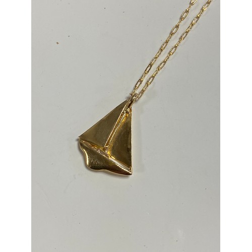 74 - A 14ct gold pendant on chain, in the form of a sailing yacht on fine link chain -