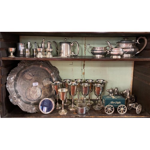 55 - A quantity of silver plated wares, to include three piece tea set, goblets, cruet, etc -